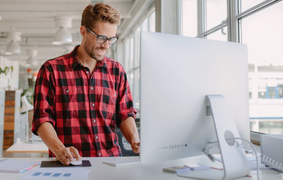 recent graduate working on his computer